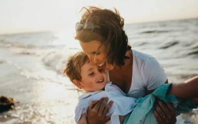 Mère qui porte son fils au bord de la mer